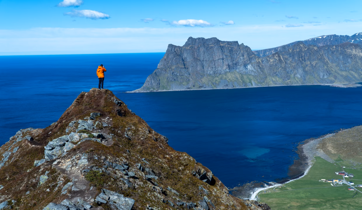 Hiker on Ridge Above Uttakleiv Beach – View from Veggen, Lofoten