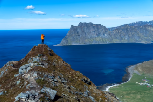 Hiker on Ridge Above Uttakleiv Beach – View from Veggen, Lofoten