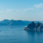 Zoomed-in view of Mosken island with the mountains of mainland Lofoten in the background